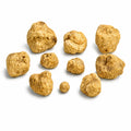 Small fresh Tuber magnatum white truffles showing naturally irregular pale ochre surfaces