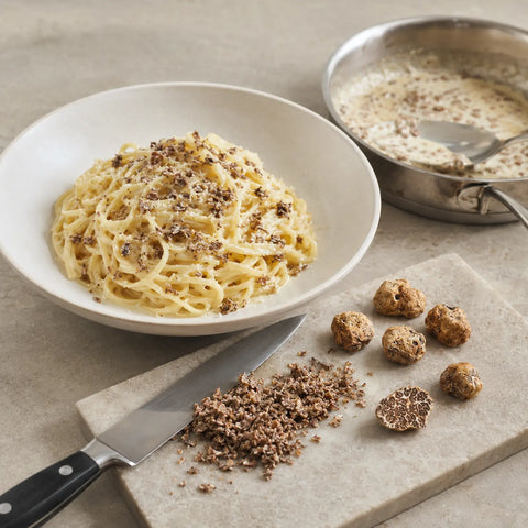 Fresh Tuber borchii B Grade incorporated into warm pasta with a light butter sauce