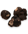 Fresh winter truffle Tuber Brumale B-grade with three black truffles on display